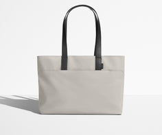 Front view of The Everywhere Tote with its leather handles up