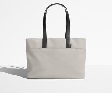 Front view of The Everywhere Tote with its leather handles up