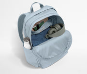 Front compartment packed with a notebooks, headphones, and clothing