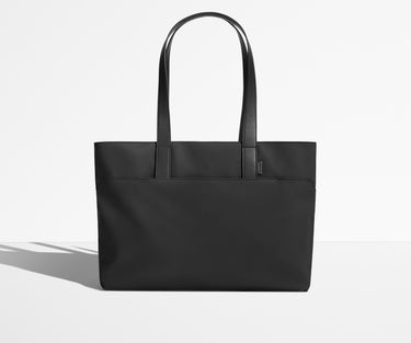 Front view of The Everywhere Tote with its leather handles up