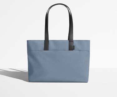 Front view of The Everywhere Tote with its leather handles up