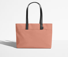Front view of The Everywhere Tote with its leather handles up