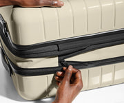 The Bigger Carry-On Flex suitcase in Salt White (Gloss) has an additional wraparound zipper to expand the suitcase 2.25" (6 cm) and increase packing space