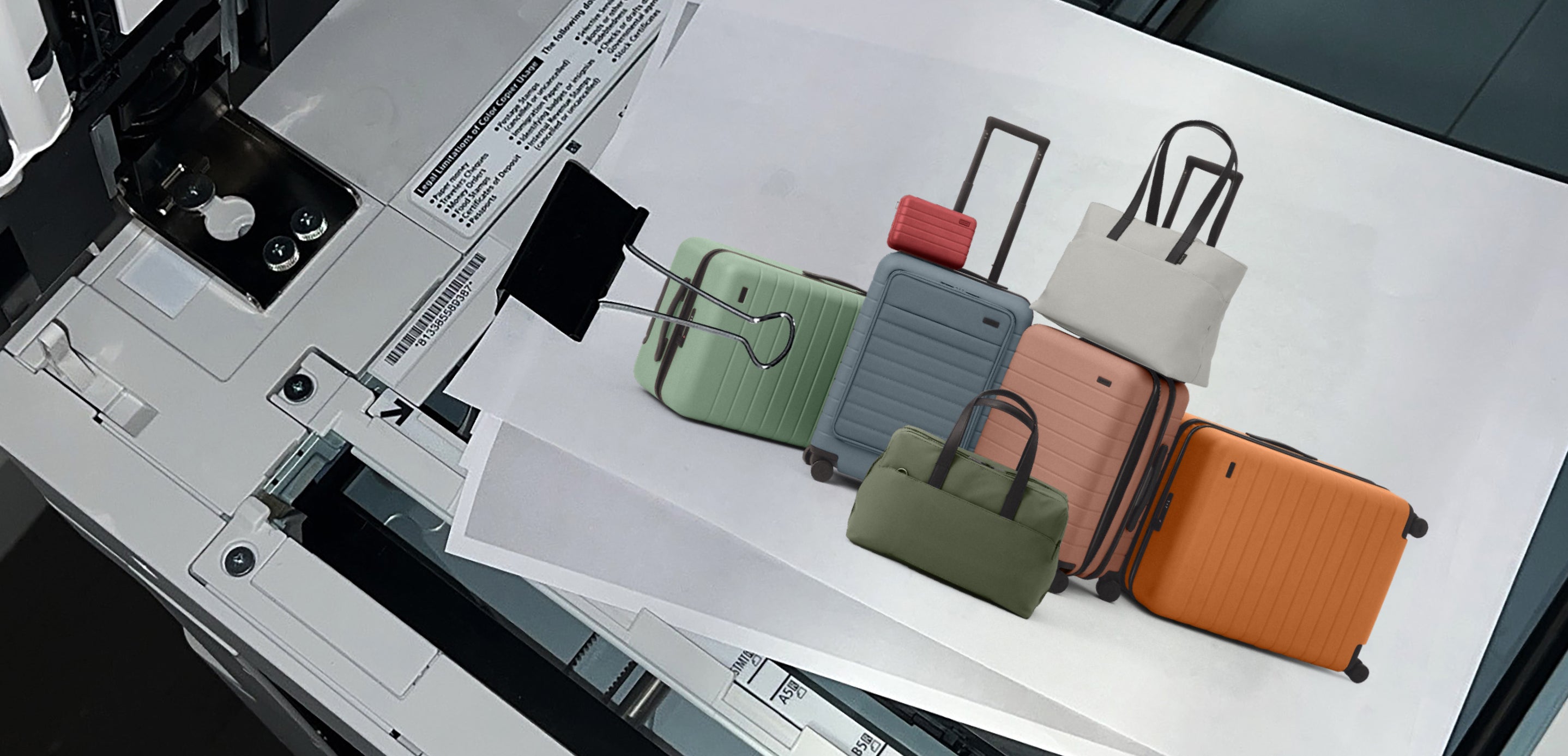 Colorful travel bags on a printed sheet with a printer in the background