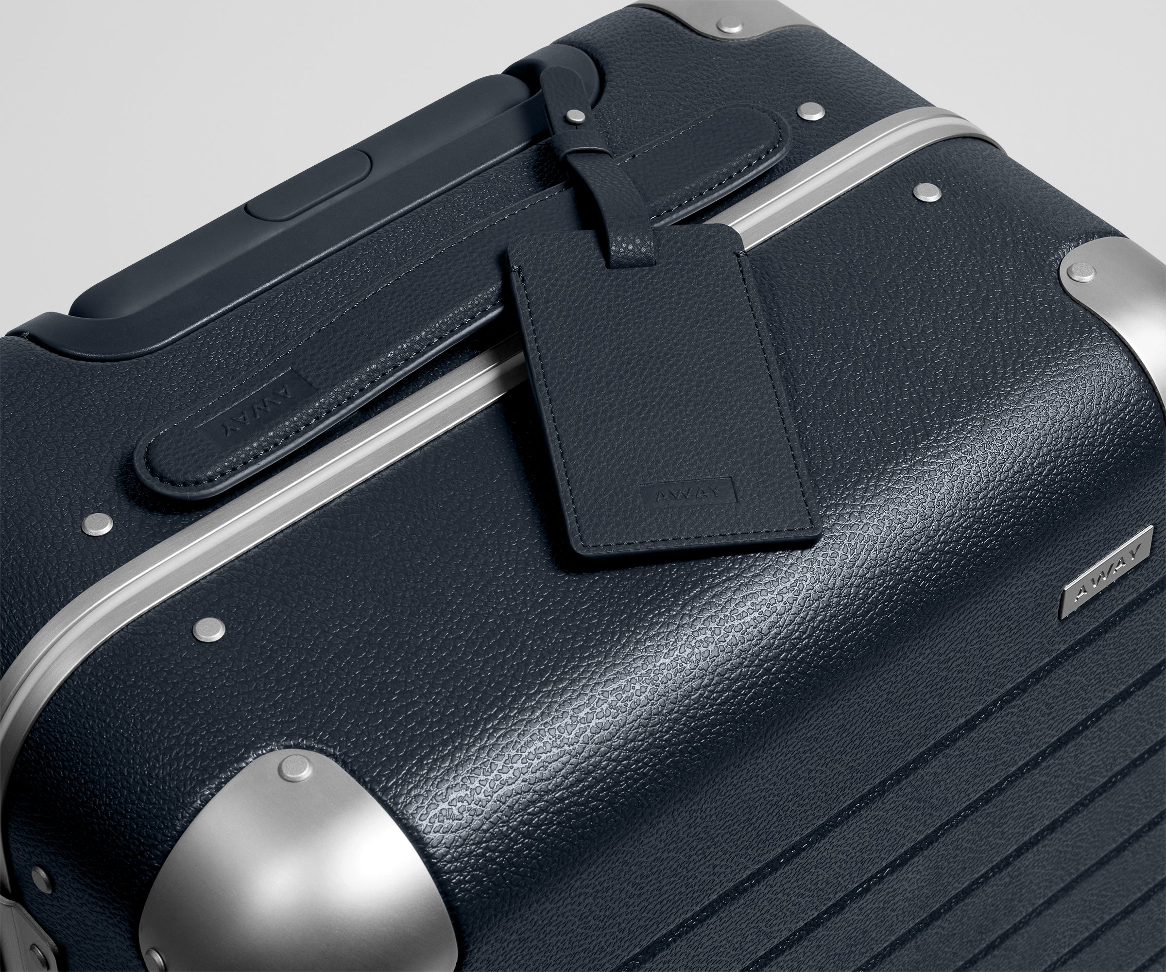 The Aluminum Edge Bigger Carry-On in Navy Blue