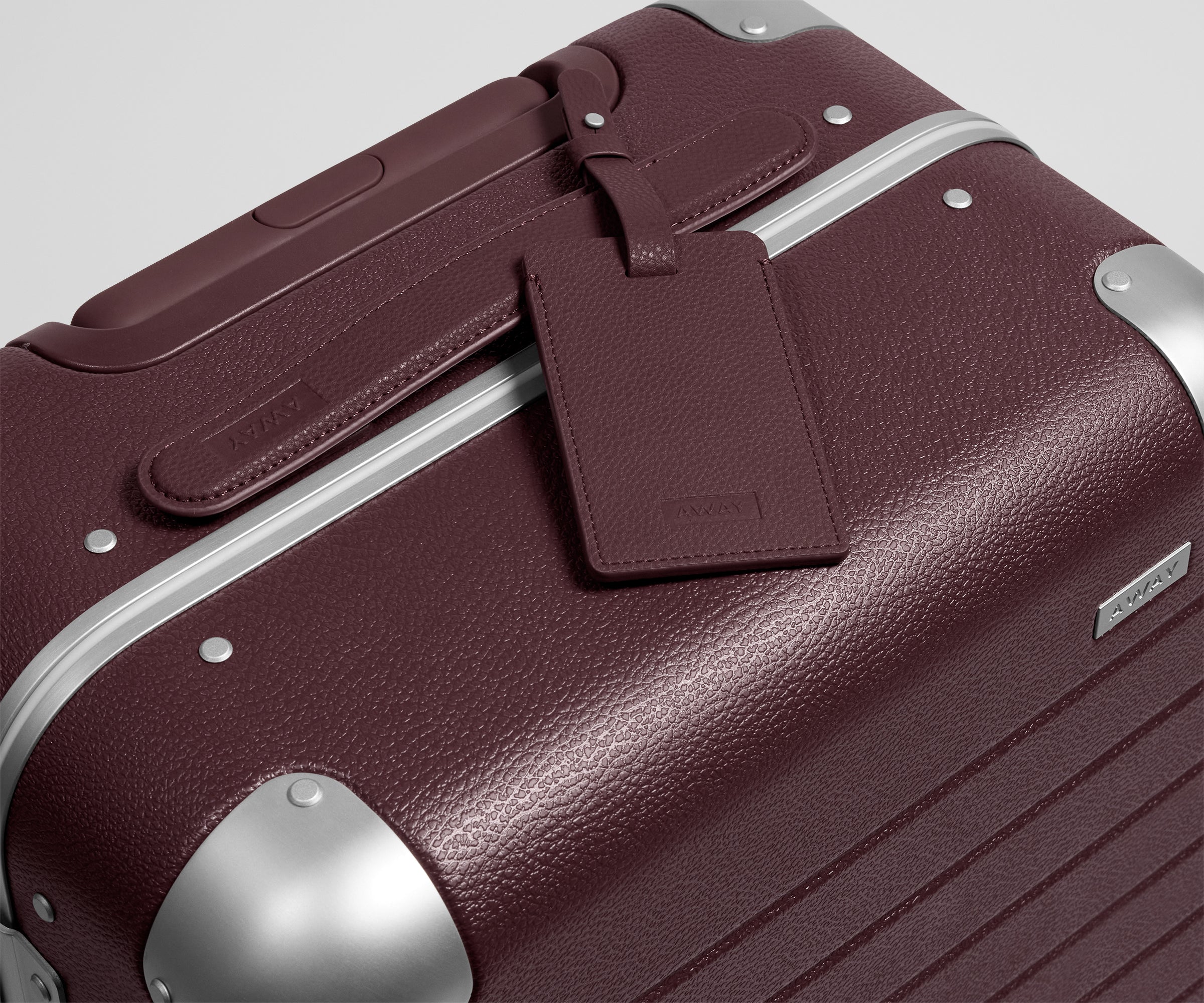 The Aluminum Edge Bigger Carry-On in Oxblood Red