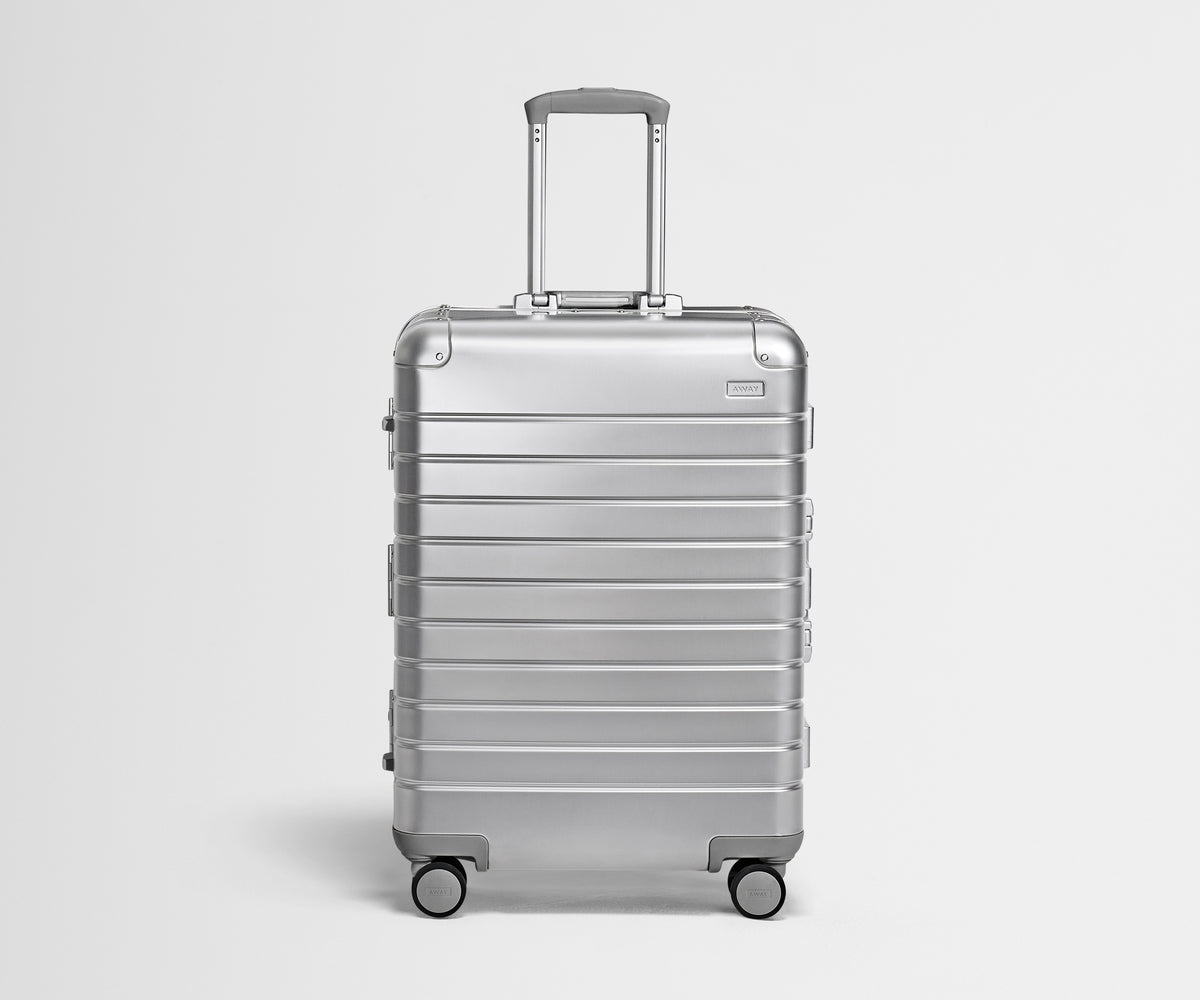 Front view of the Medium: Aluminum suitcase in Silver with handles raised