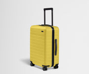 Angled product view of The Bigger Carry-On suitcase in Sunshine Yellow