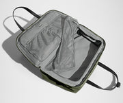 Green duffle bag with open front compartment on a white background