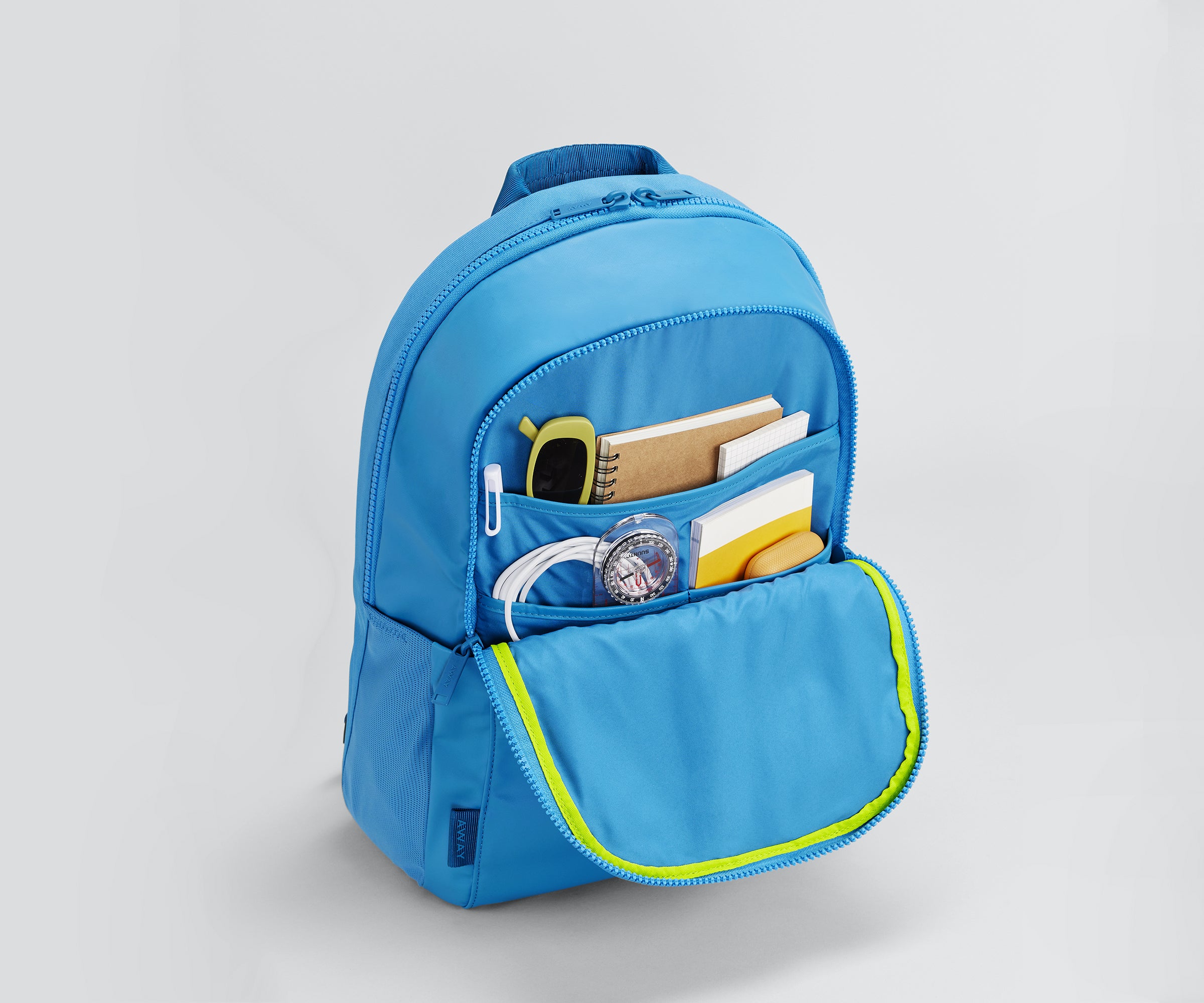 Front pocket packed with a noteboook, phone, beanie, and other daily essentials