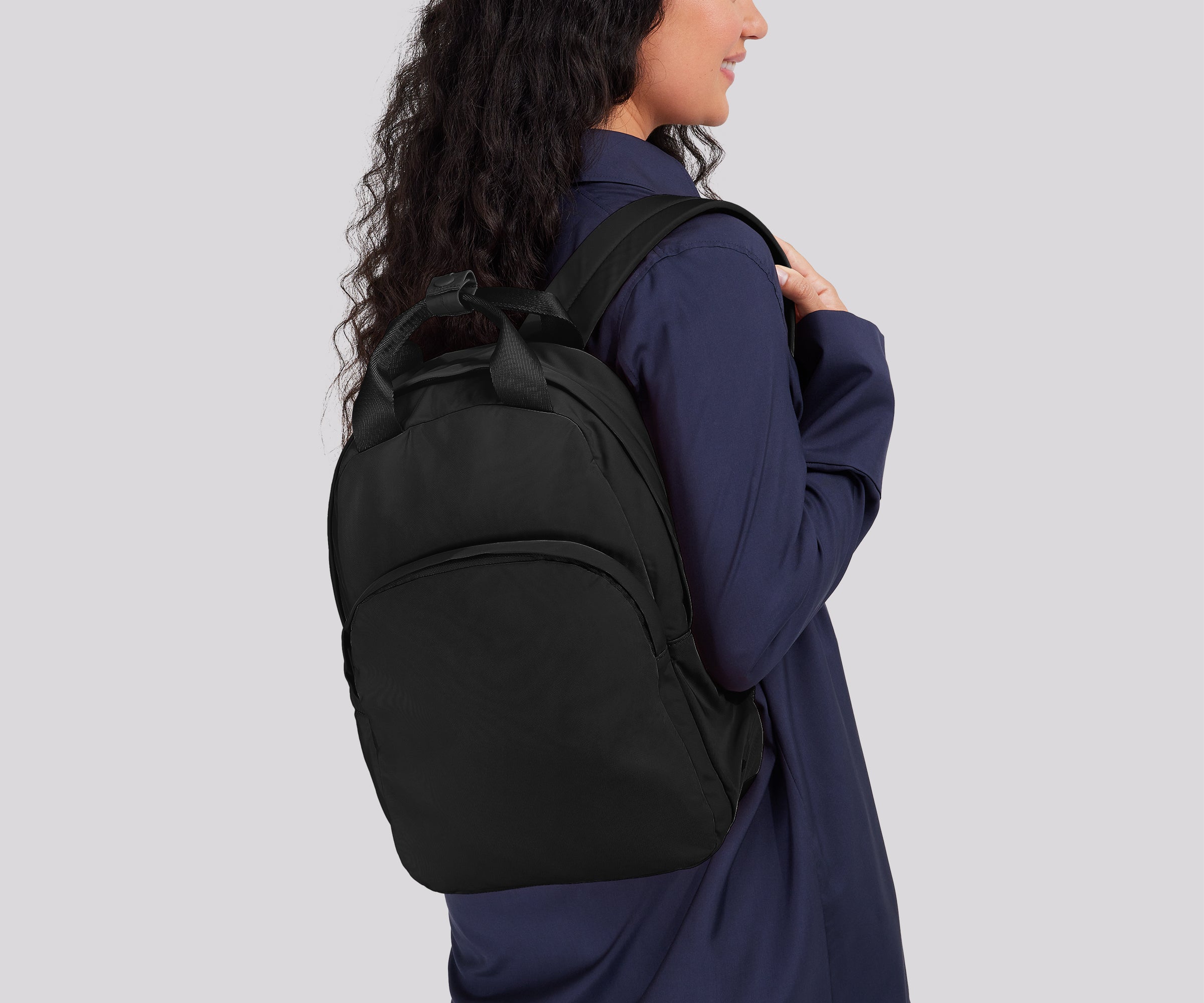 Person wearing the Featherlight Backpack on one shoulder