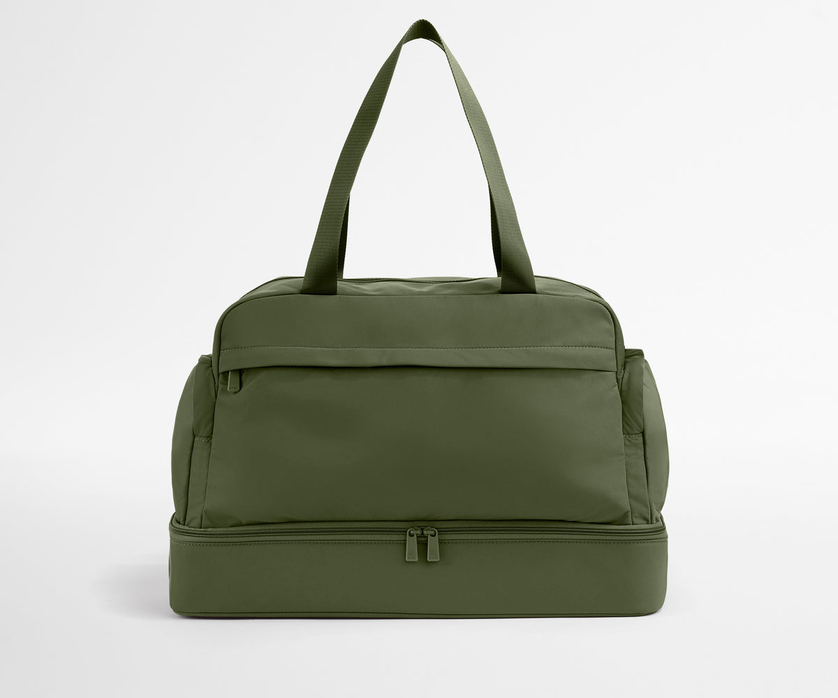 Green duffel bag on a light gray background