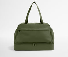 Green duffel bag on a light gray background