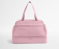 Pink duffel bag on a light gray background