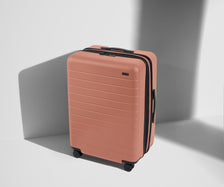 Angled product view of The Medium Flex suitcase in Clay Pink
