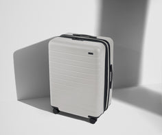 Angled product view of The Medium Flex suitcase in Cloud Gray