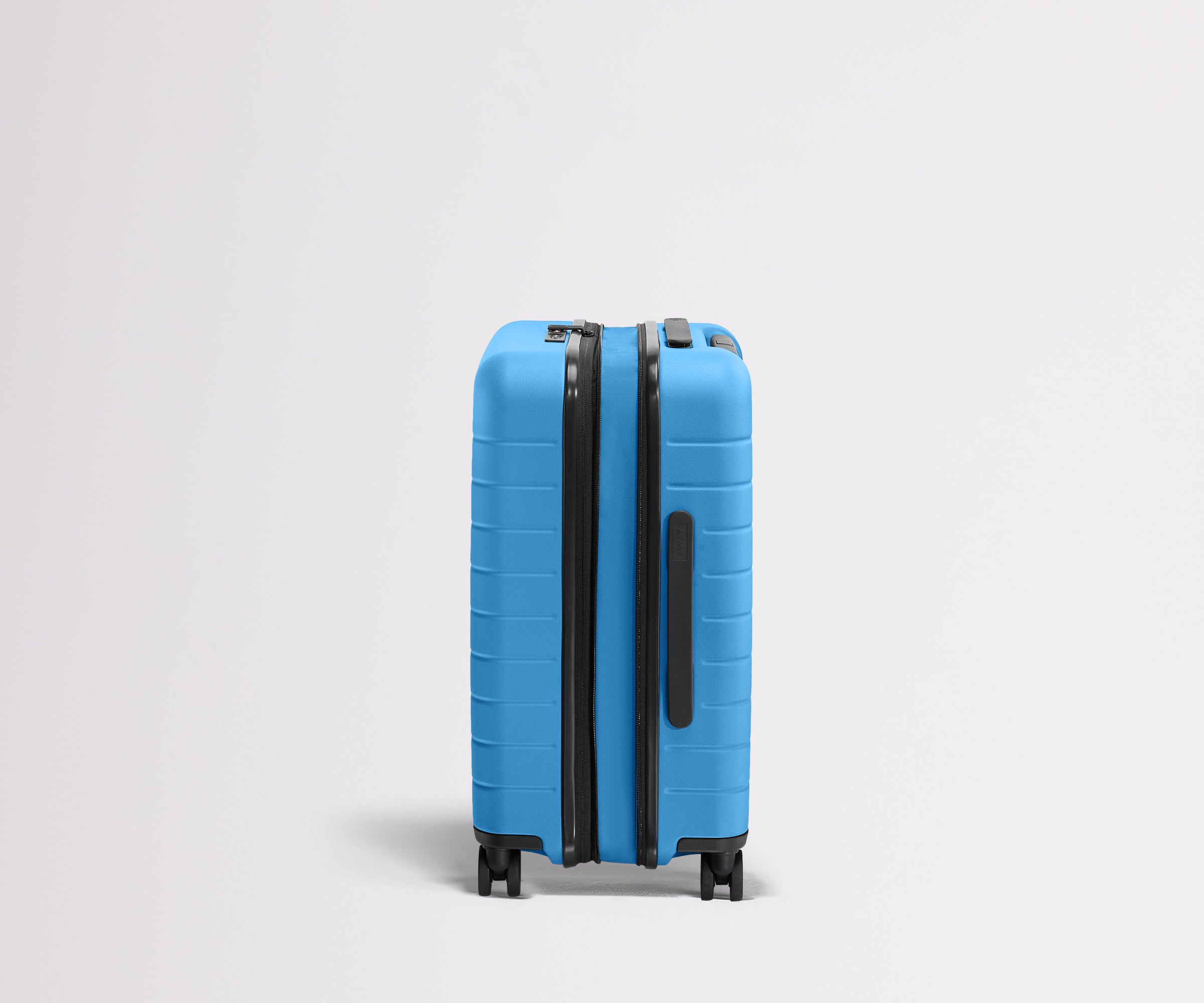 Side product view of The Carry-On Flex suitcase in Splash Blue shown fully expanded