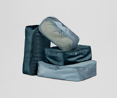 Set of blue packing cubes on a light gray background