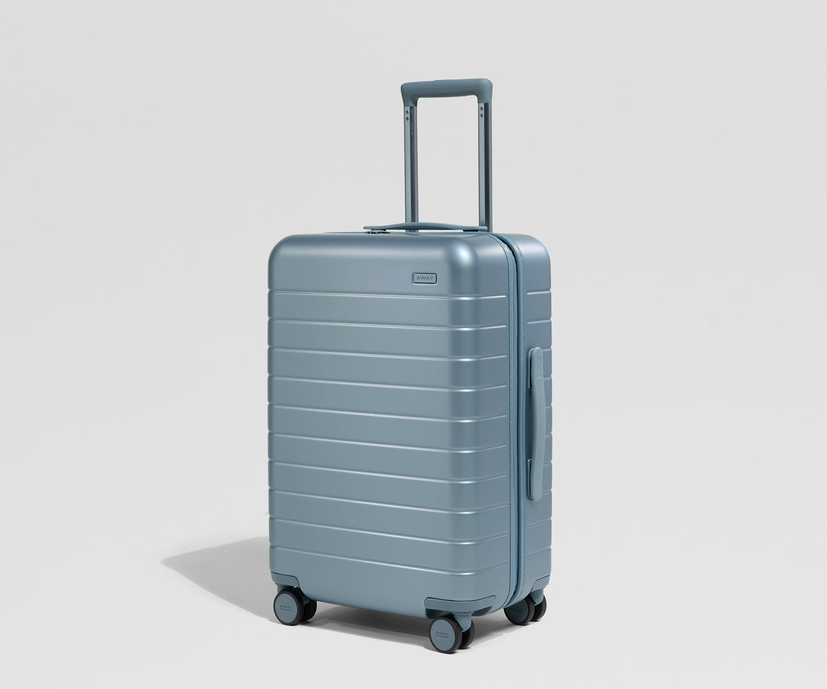 Blue suitcase on a light gray background