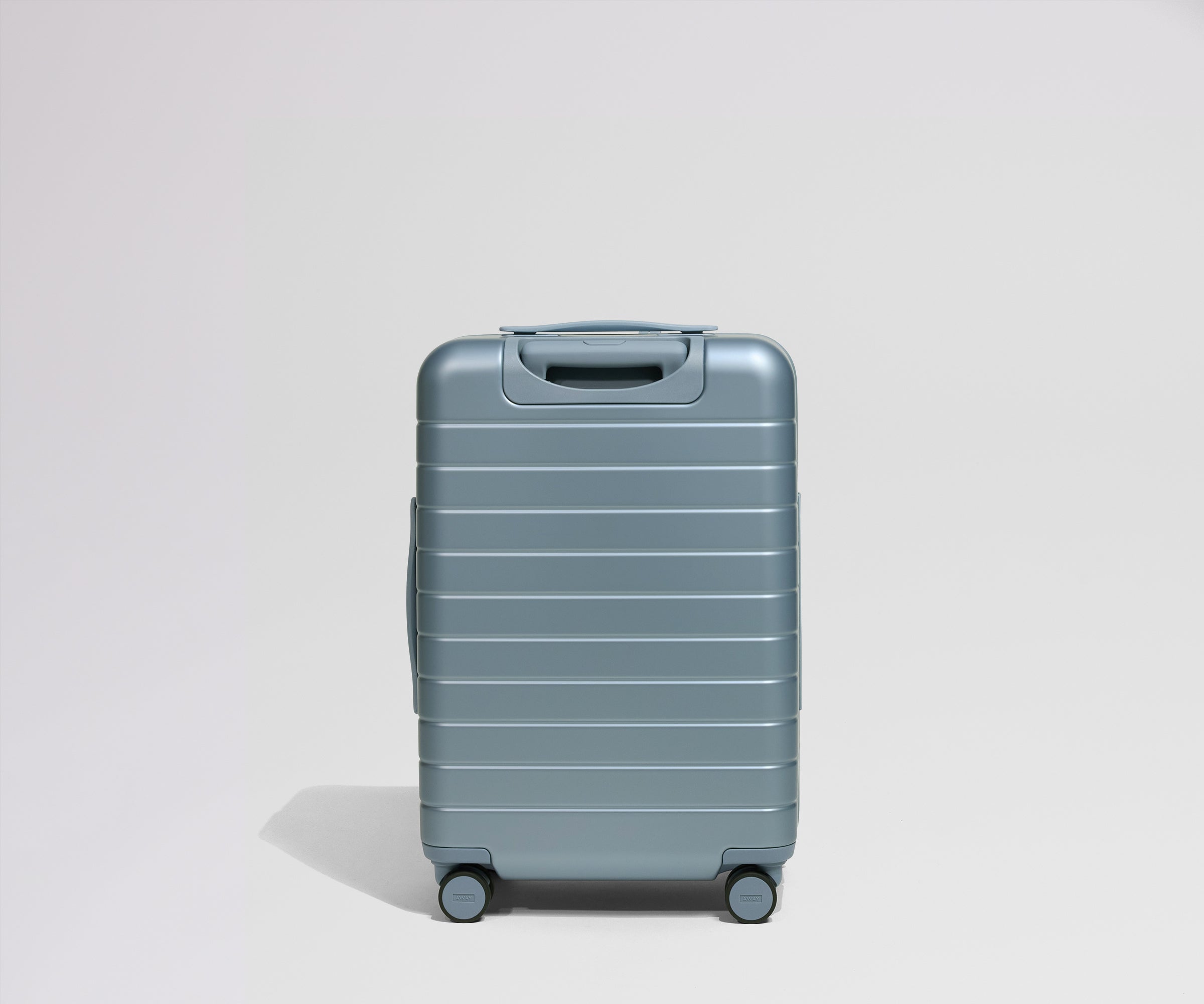 Blue suitcase on a light gray background