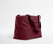 Maroon tote bag on a light gray background