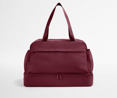 Maroon duffel bag on a light gray background