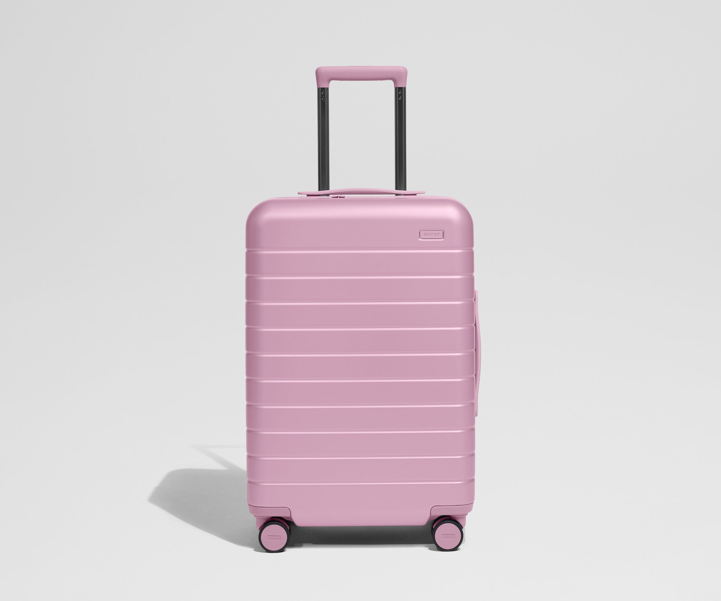 Pink suitcase on a light gray background