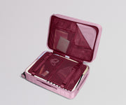 Pink suitcase with open lid on a light gray background