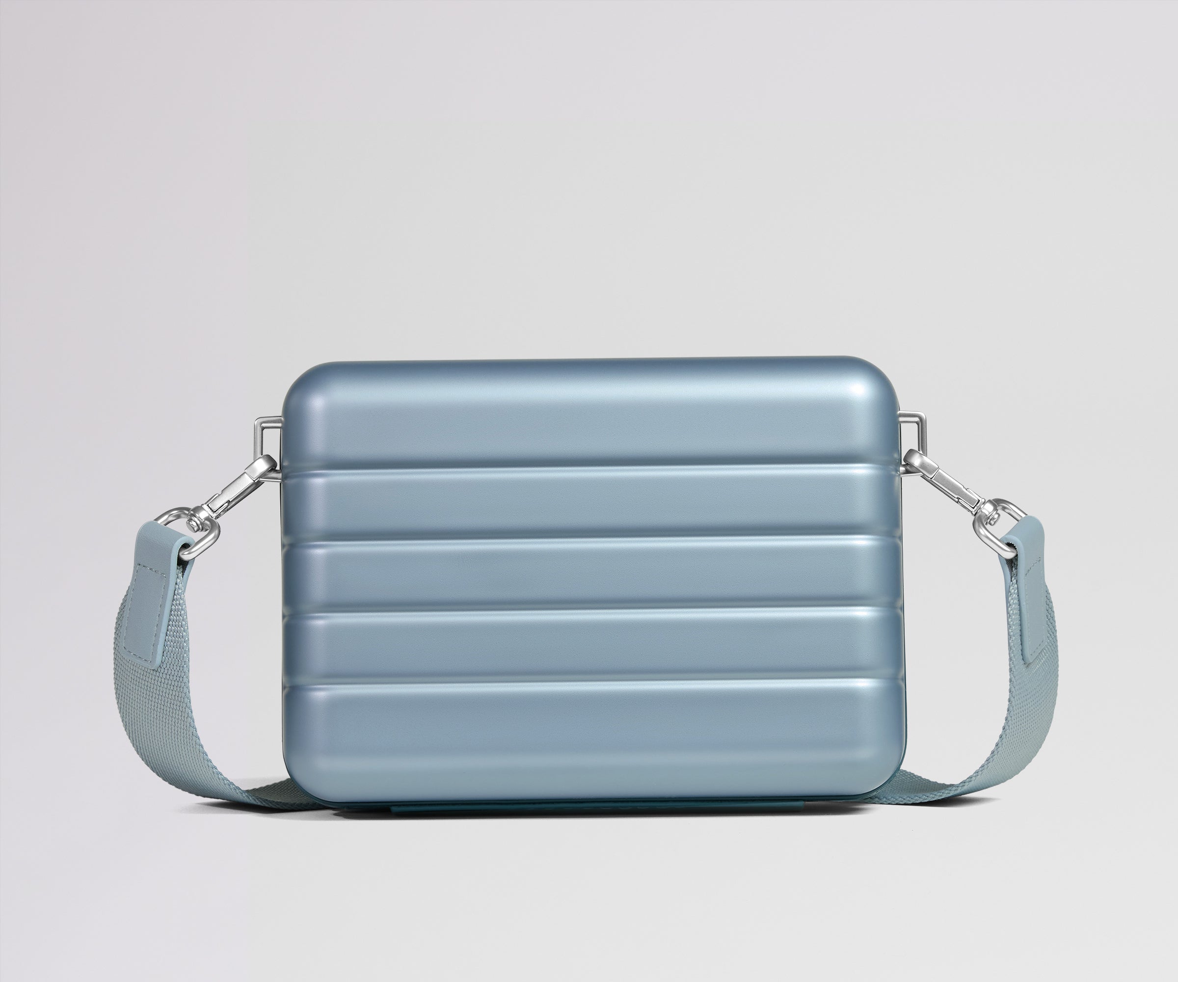 Blue crossbody bag on a light gray background