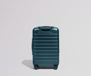 Teal suitcase on a light gray background