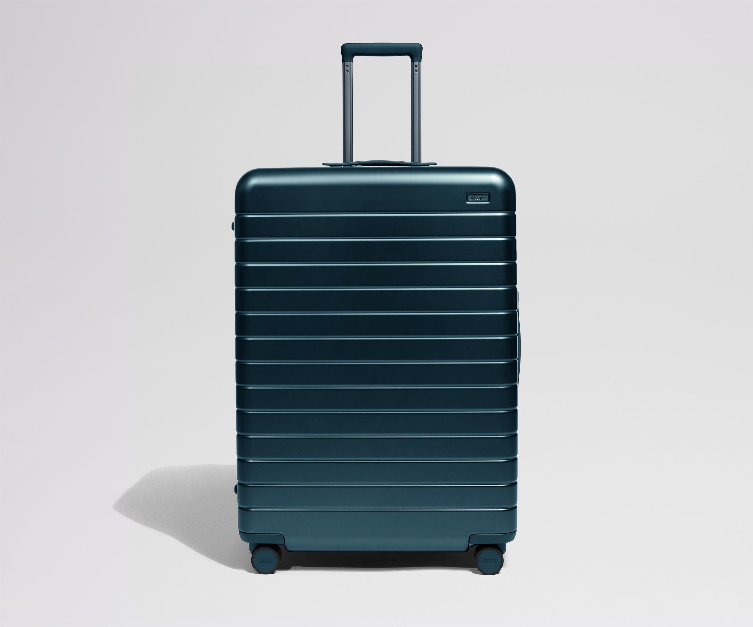 Teal suitcase on a light gray background