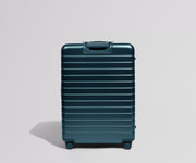 Back view of a teal suitcase on a light gray background