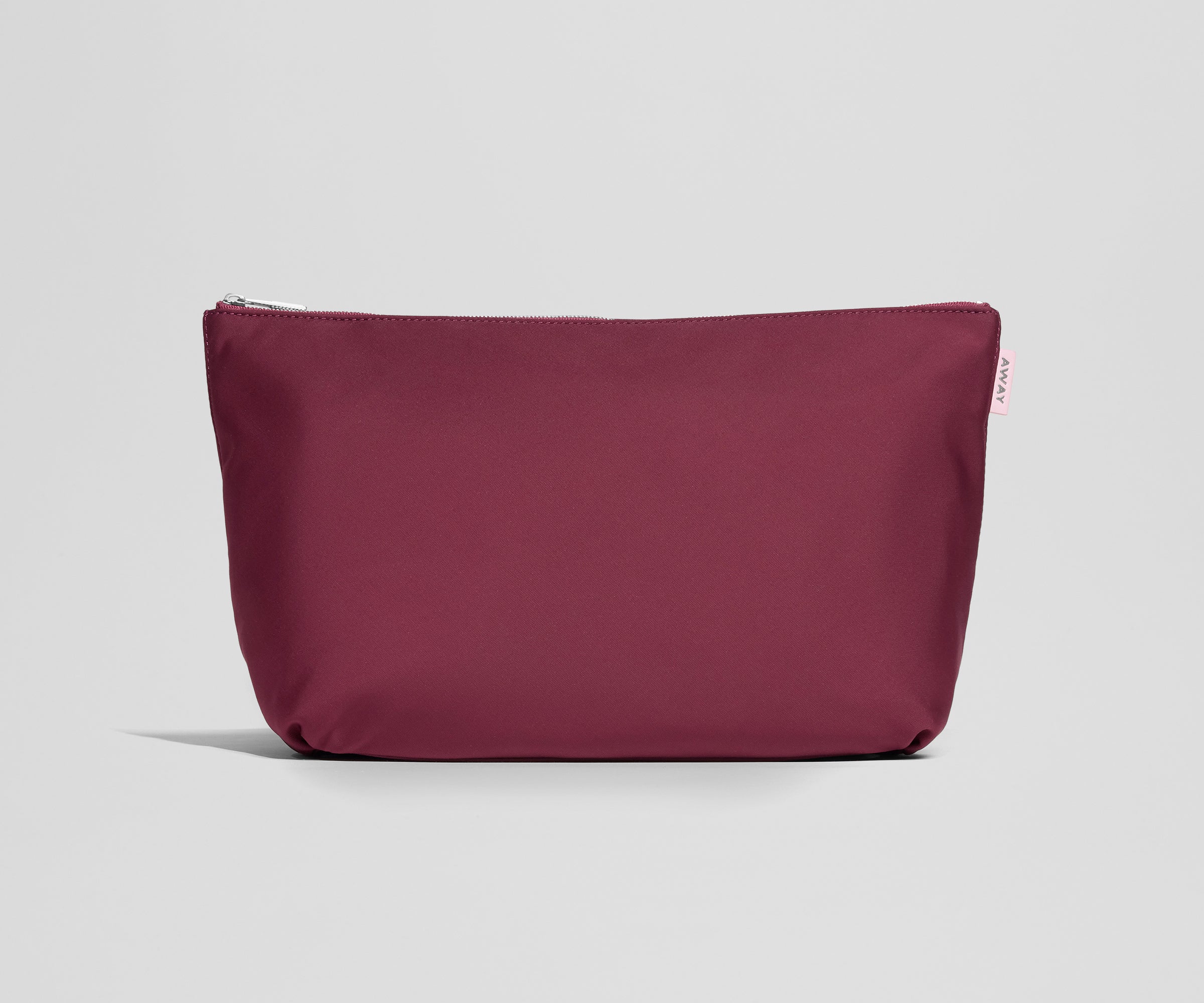Maroon pouch with a zipper on a light gray background
