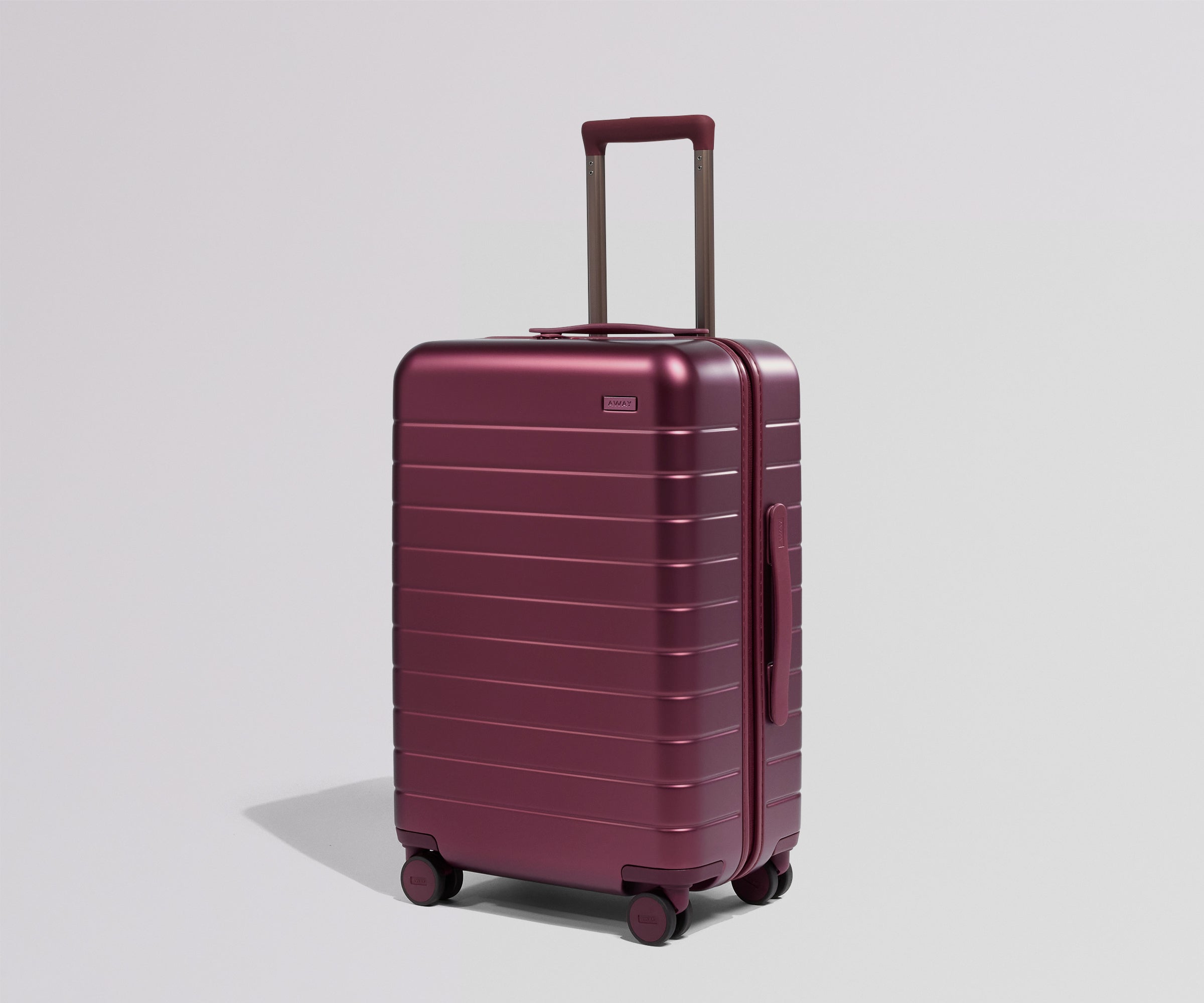 Maroon suitcase on a light gray background