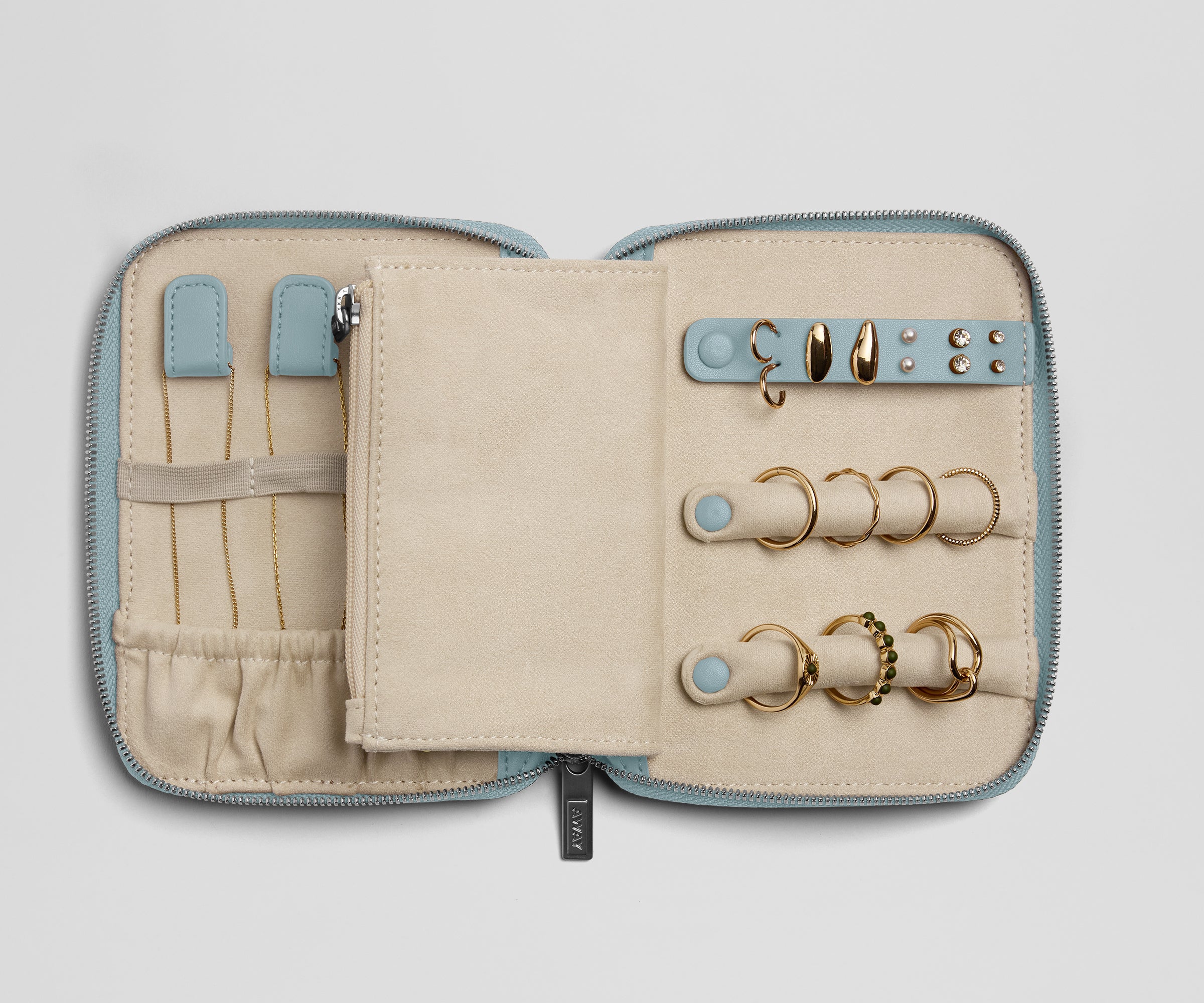 Jewelry organizer with gold rings on a light gray background