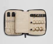 Jewelry case with gold rings on a light gray background