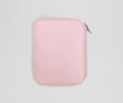 Pink zippered jewelry case on a light gray background