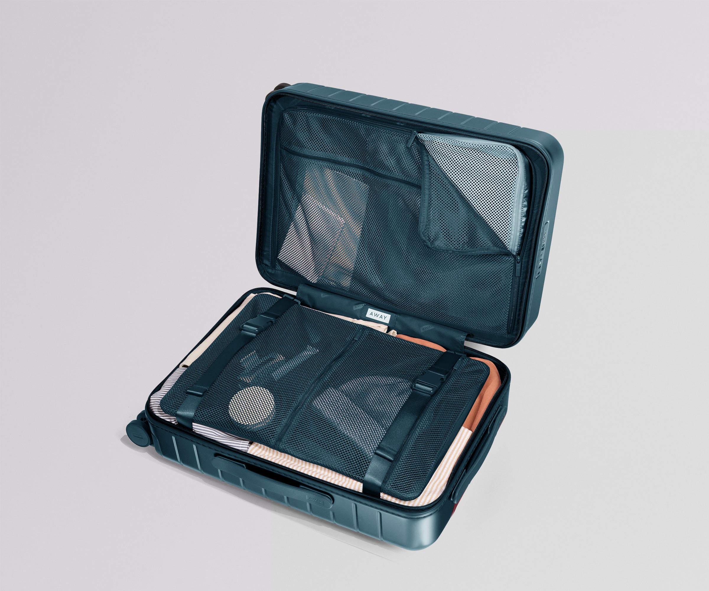 Open teal travel case with mesh interior on a light gray background