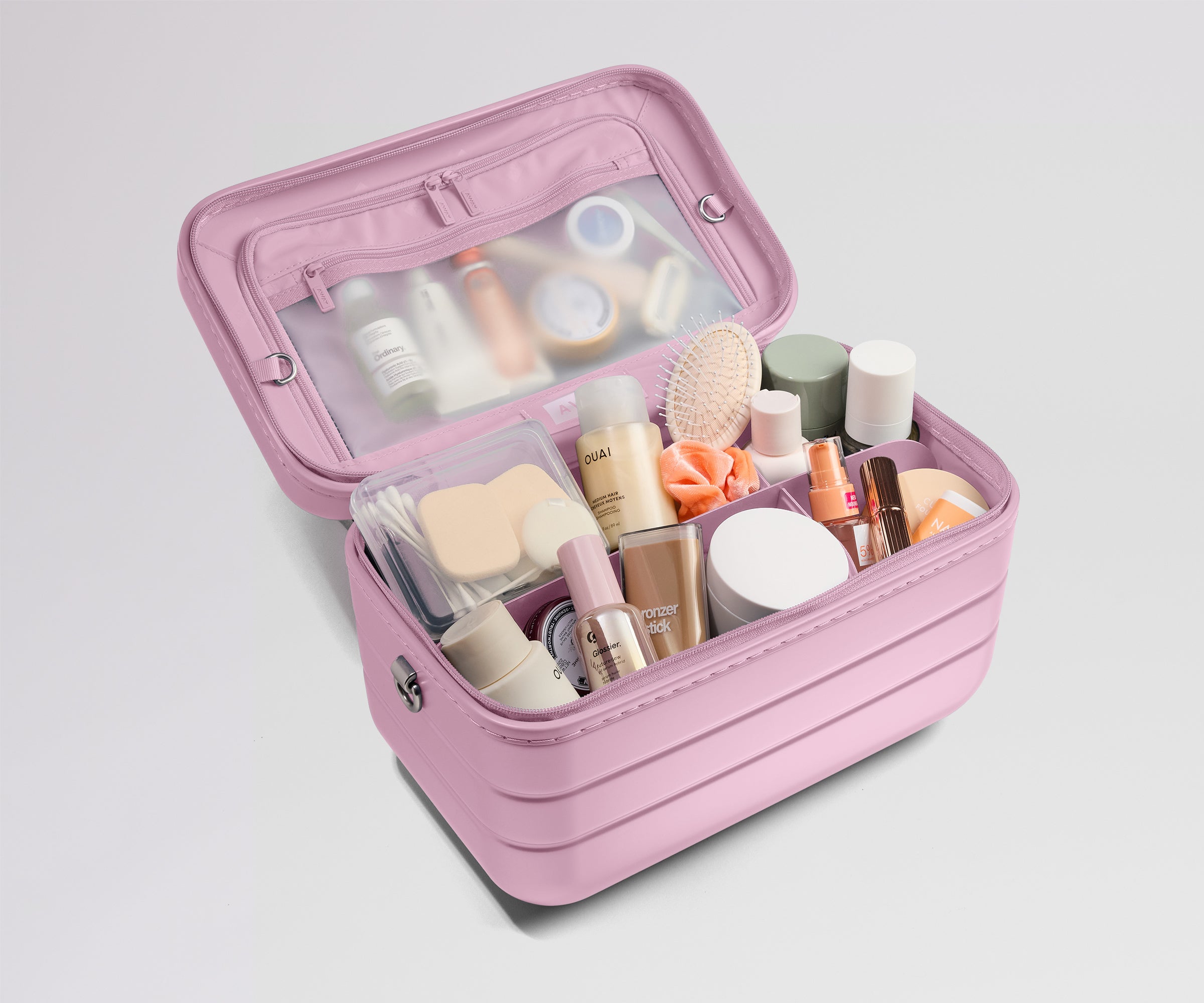 Pink makeup case with various cosmetic items on a light gray background
