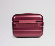 Red metallic suitcase on a light gray background