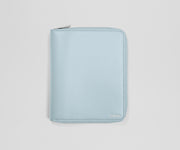 Light blue travel wallet with an AWAY logo on a light gray background