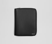 Black leather wallet with 'AWAY' branding on a light gray background