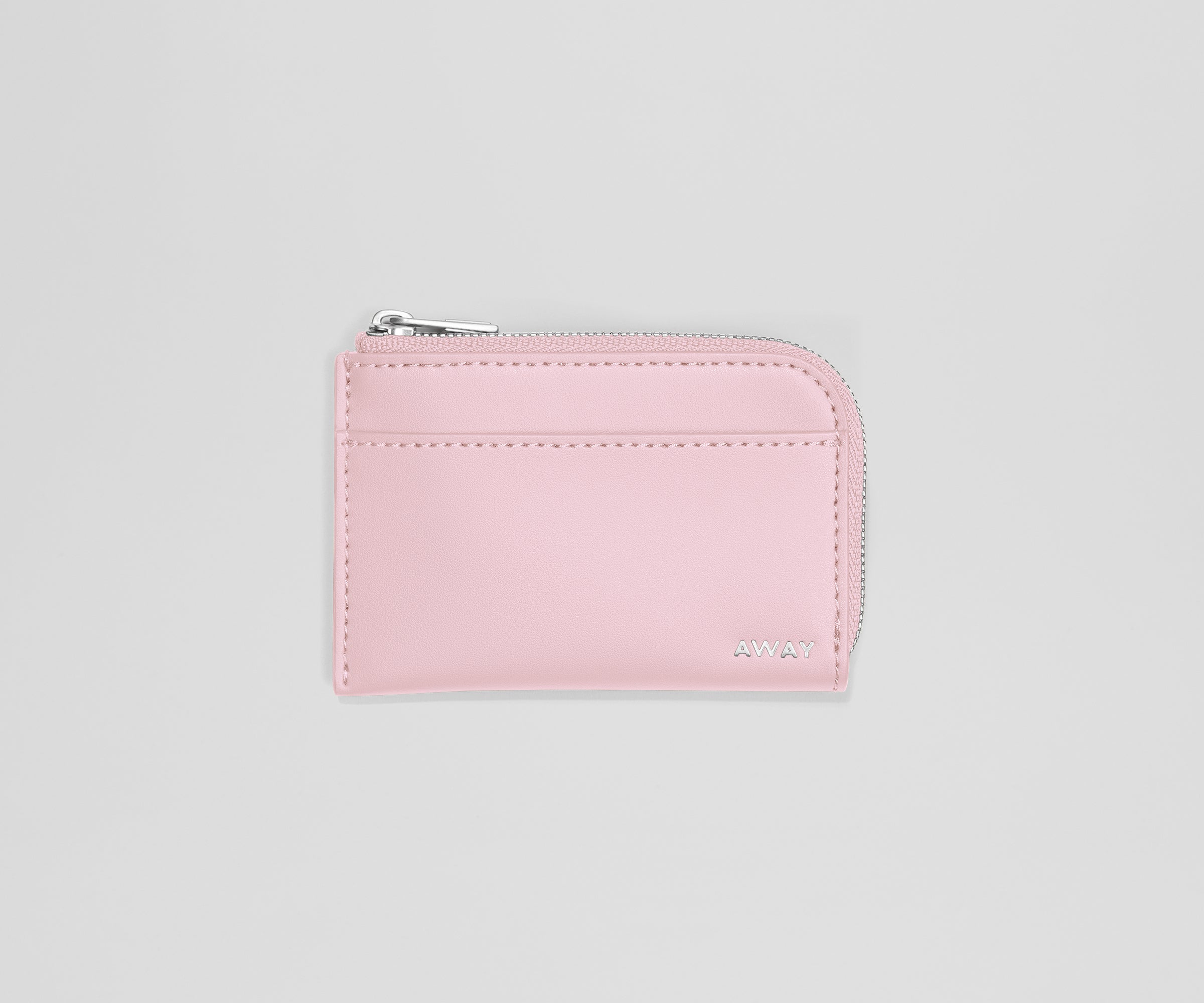 Pink wallet with a zipper on a light gray background