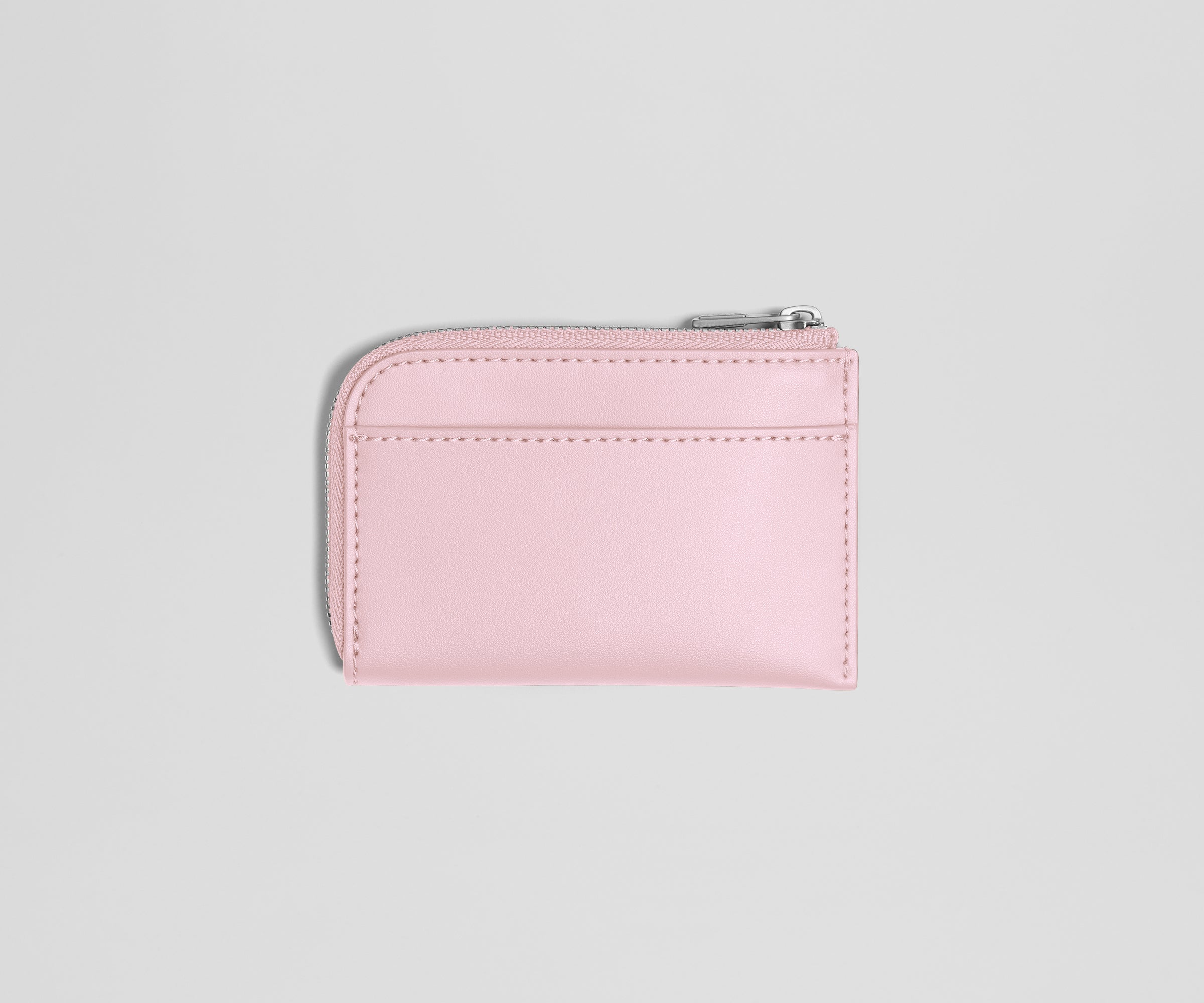 Pink wallet with a zipper on a light gray background