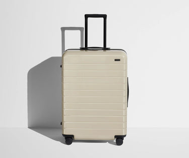 Front product view of The Medium suitcase in Salt White (Gloss) with raised handle