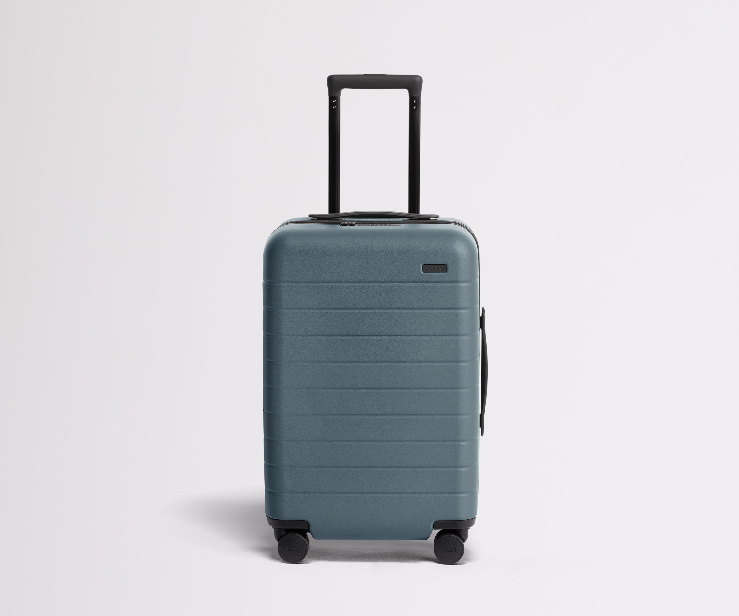 Front product view of The Carry-On suitcase in Coast Blue with raised handle