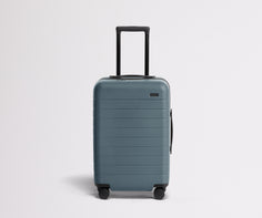 Front product view of The Carry-On suitcase in Coast Blue with raised handle