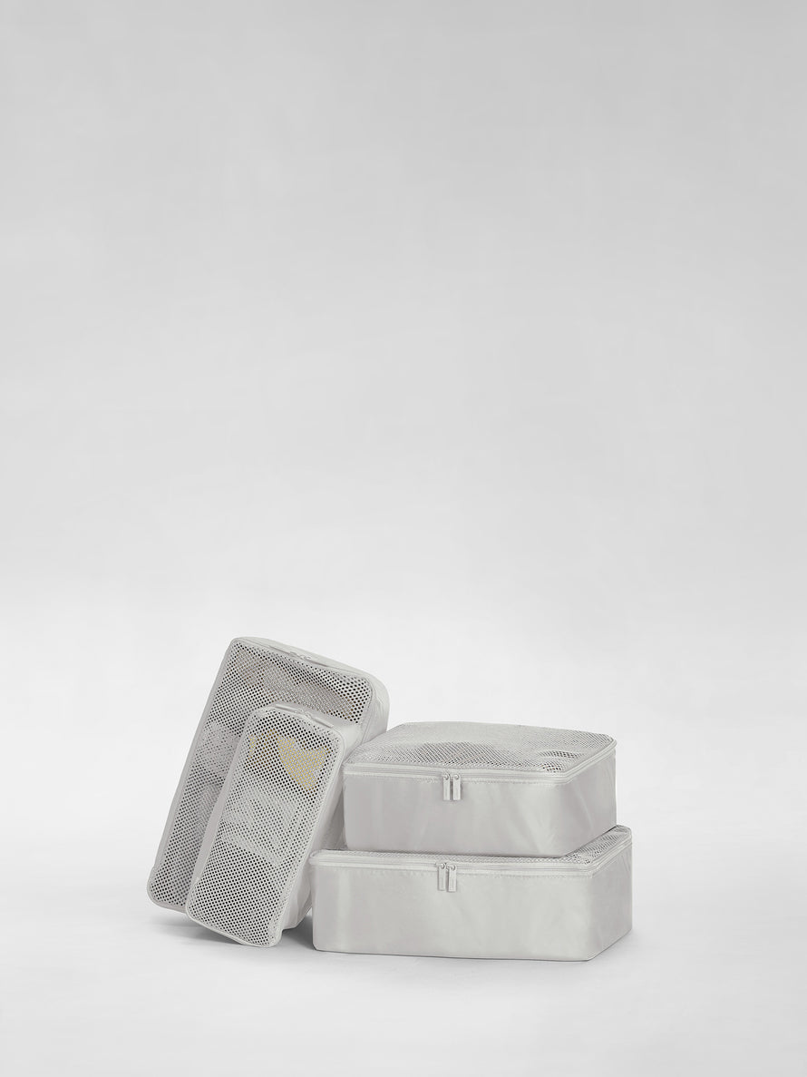 Stack of four Cloud Gray Packing Cubes