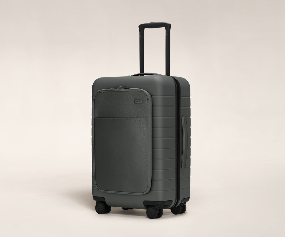 The Bigger Carry-On with Pocket in Asphalt shown at an angle with raised telescoping handle