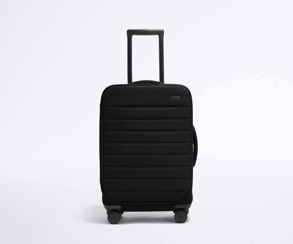 Front product view of The Softside Carry-On suitcase in Jet Black with raised handle